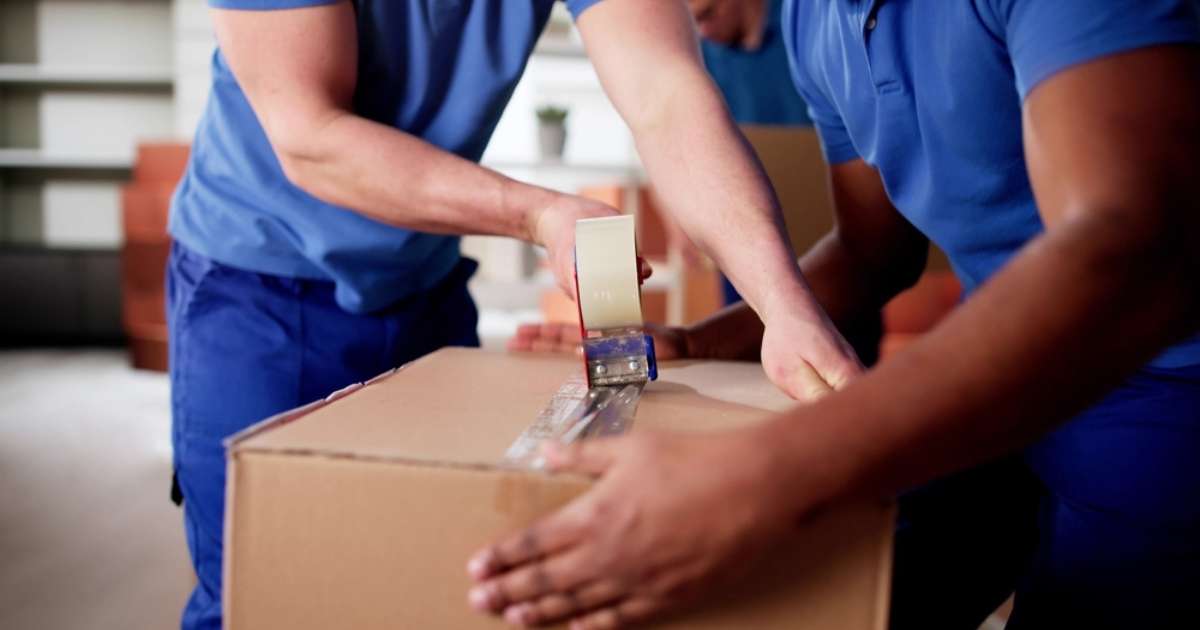 Lodi WI movers taping a box.