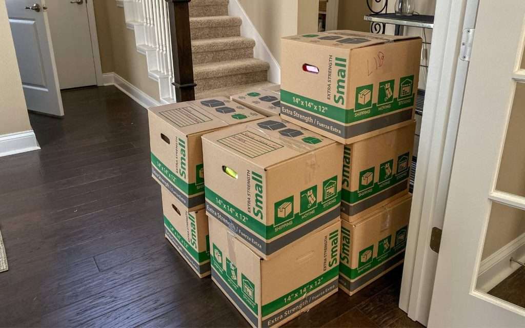 Boxes from a Wisconsin Dells moving company stacked inside a home